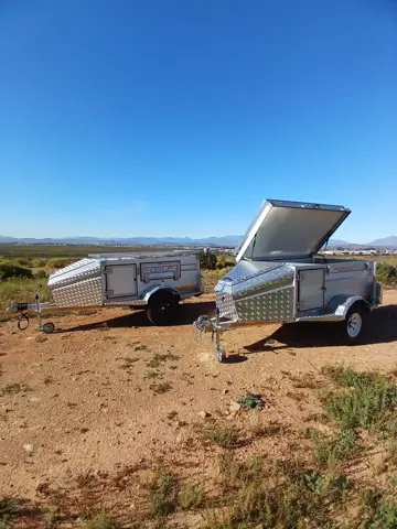 Two Tracker trailers, one with the lid open