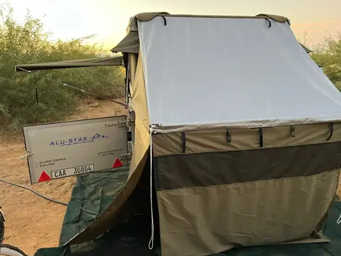 Tracker with a rooftop tent and annex set up