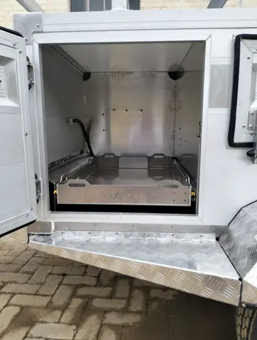 Tracker front door open, showing the fridge slide