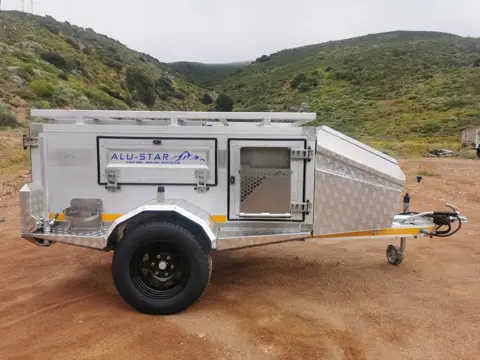 Tracker with fixed roof, roof rack and front door, side view